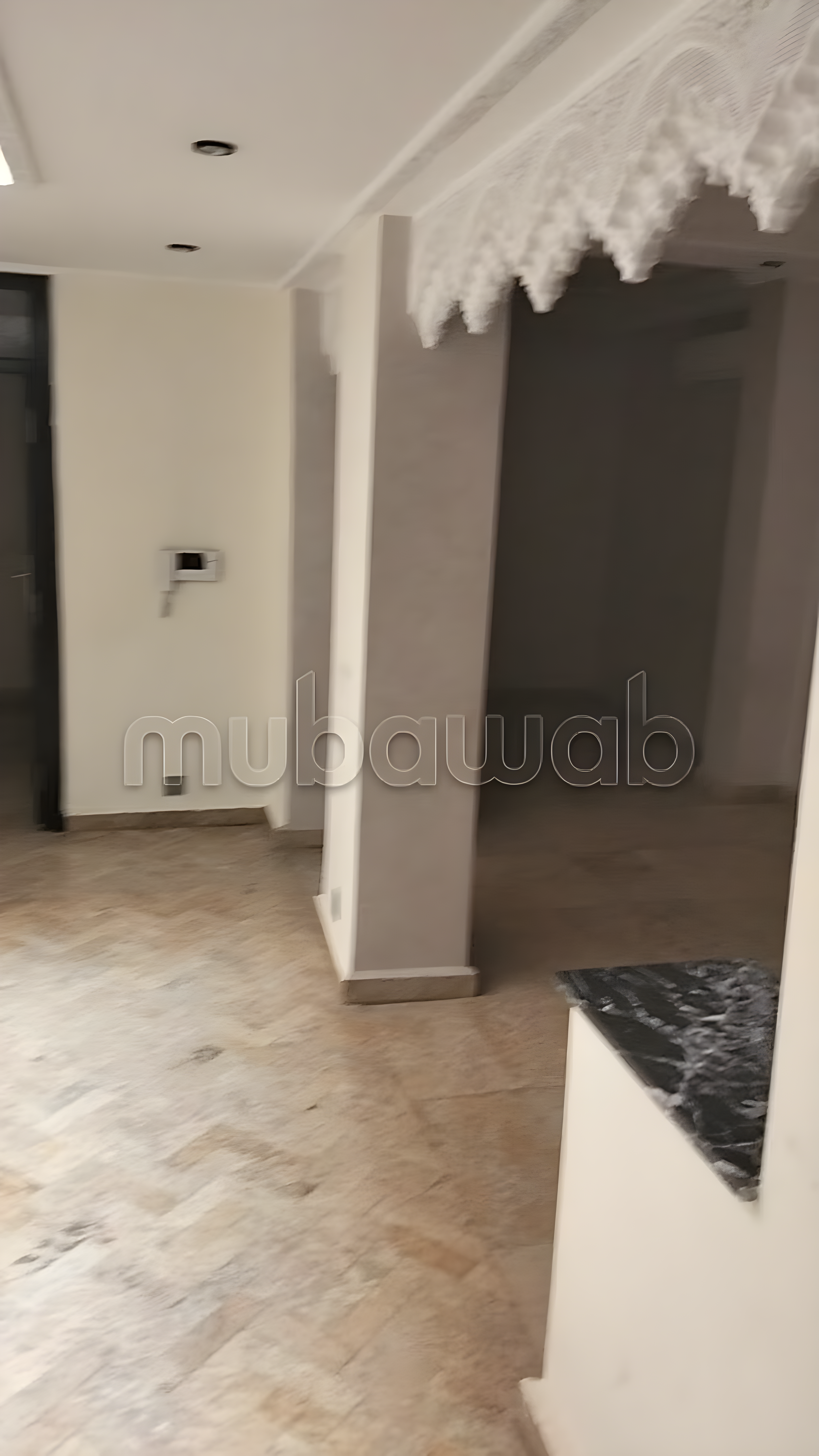 Salon in Arset Ben Chebli with tiled flooring, marble counter, and pillars.