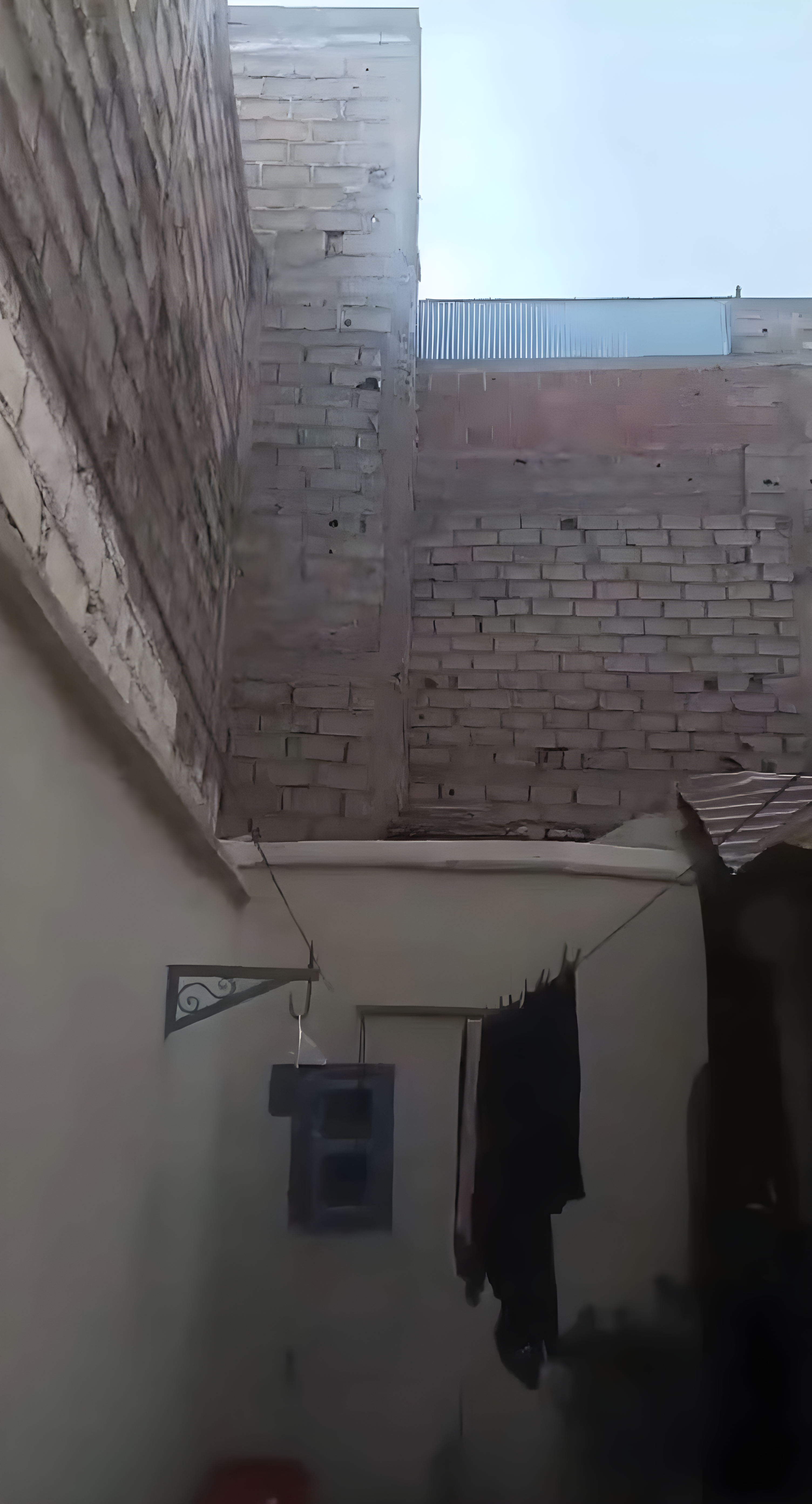 Courtyard of a guesthouse in Riad Zitoun district with laundry hanging.