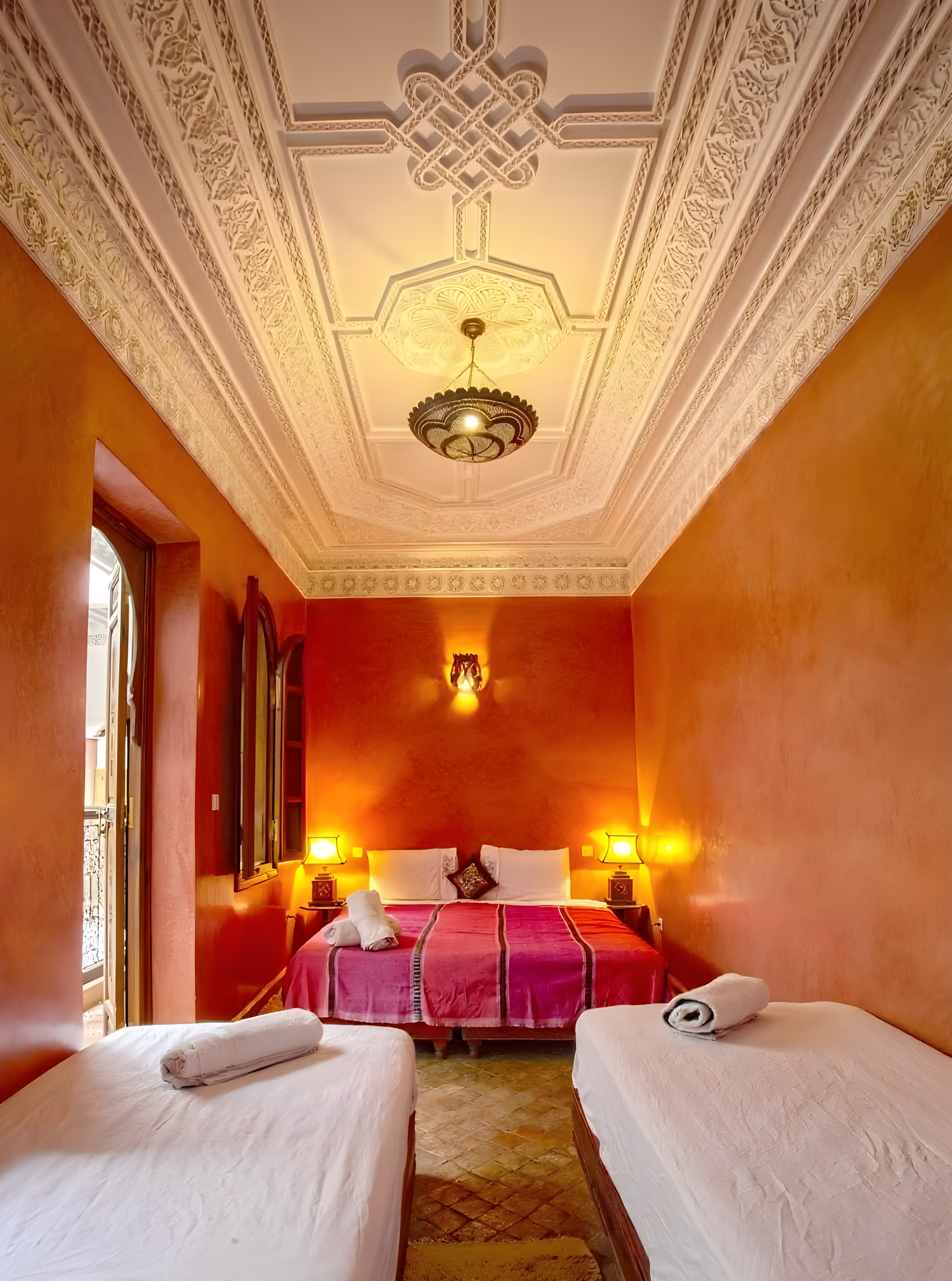 Moroccan guesthouse bedroom with ornate ceiling in Kennaria.