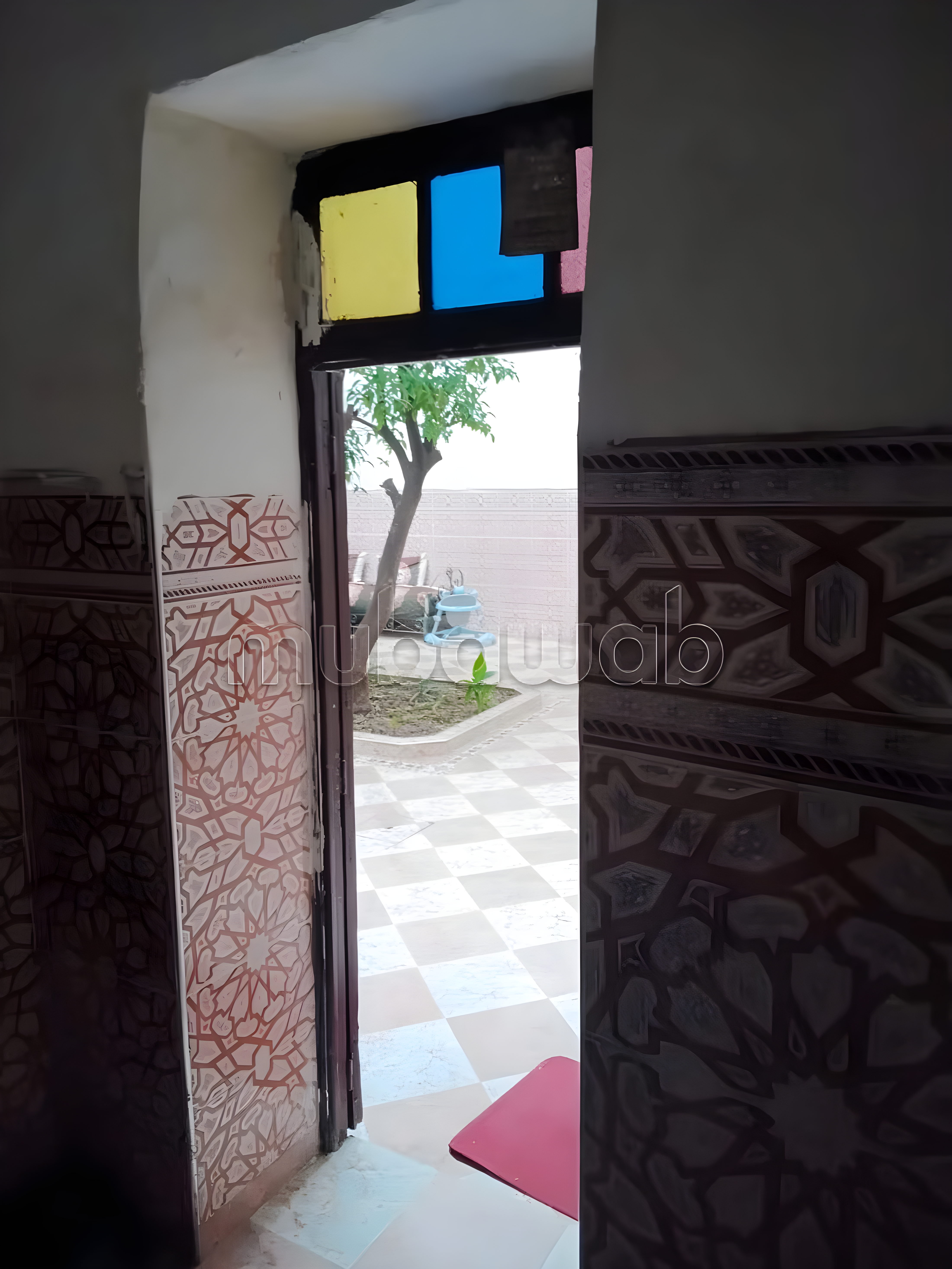 Riad courtyard in Ben Saleh with Moroccan tiles and outdoor seating.