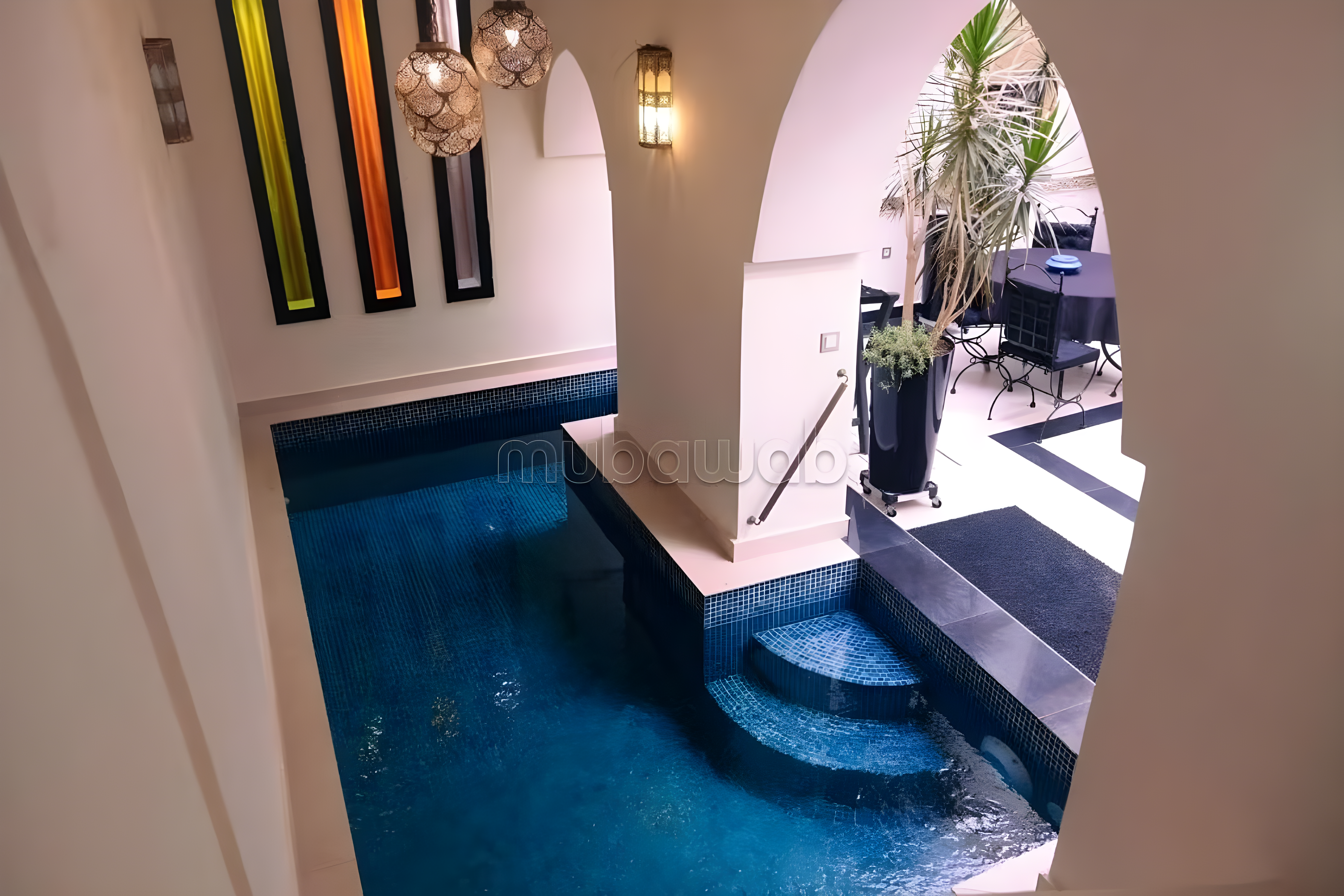 Courtyard of Ben Saleh guesthouse with pool and Moroccan arches.