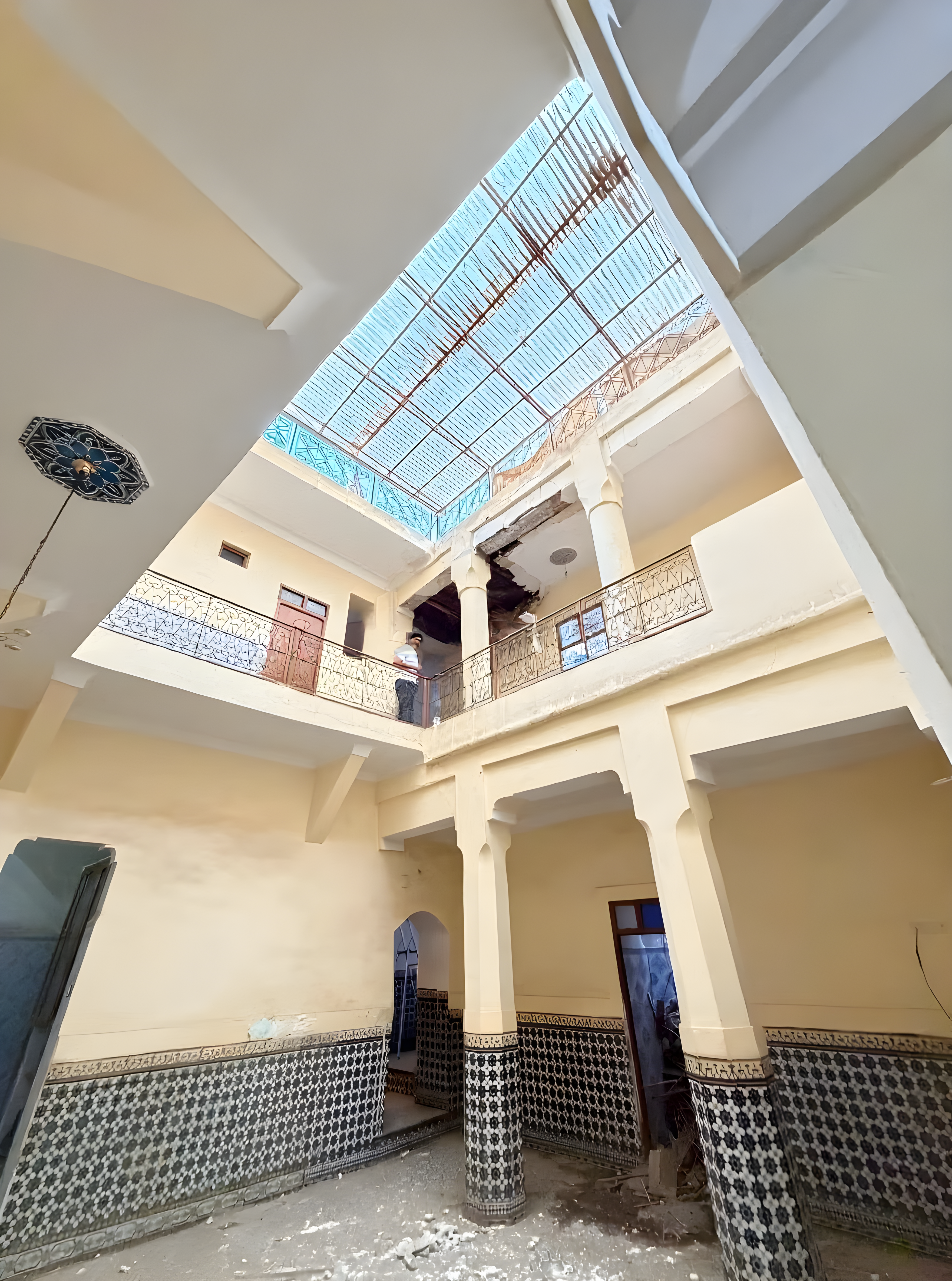 Moroccan riad courtyard with tiled walls and skylight in Essebtiyen guesthouse.