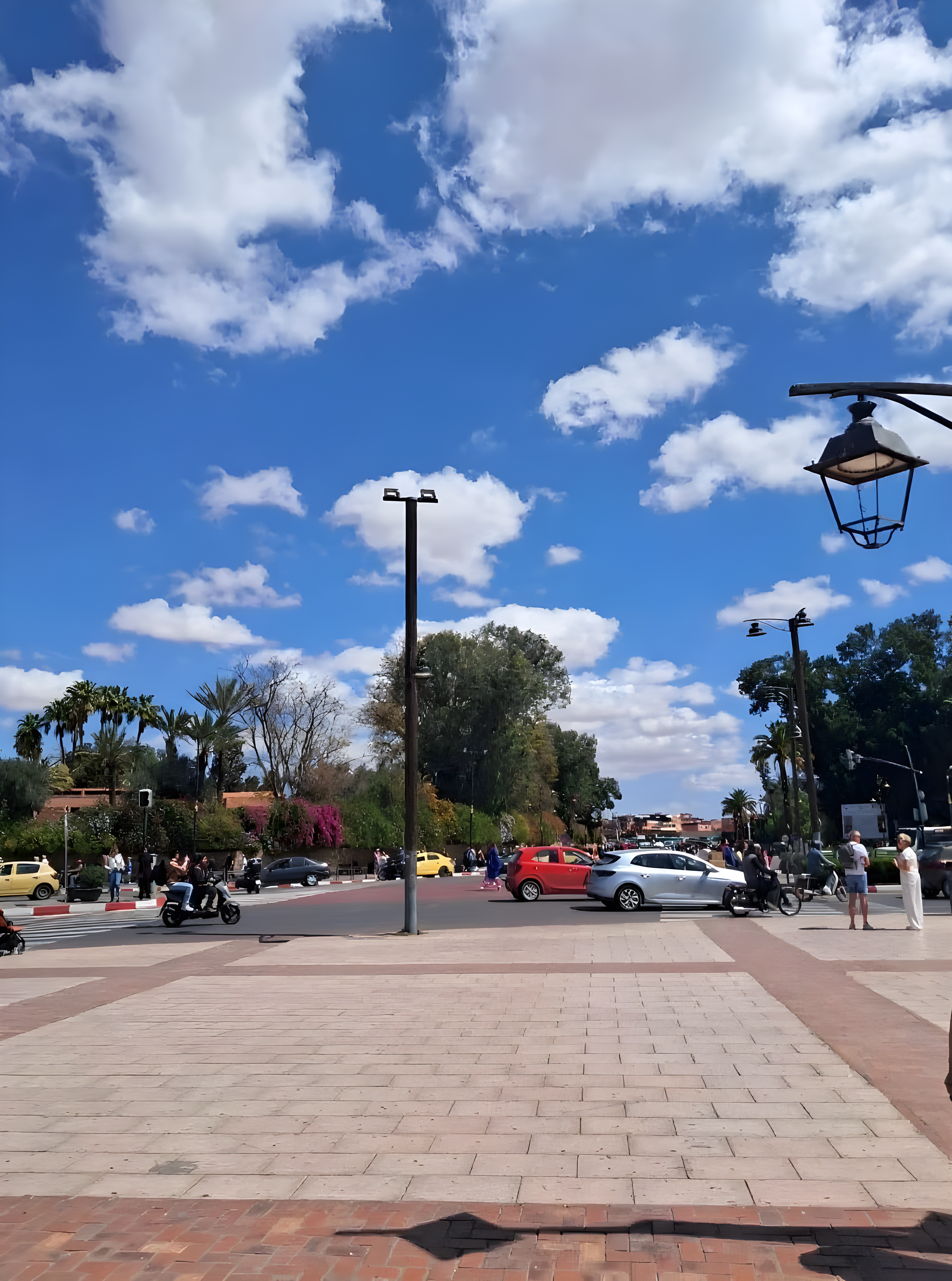 Outdoor urban space in Ben Saleh district with vehicles, pedestrians, and streetlights.