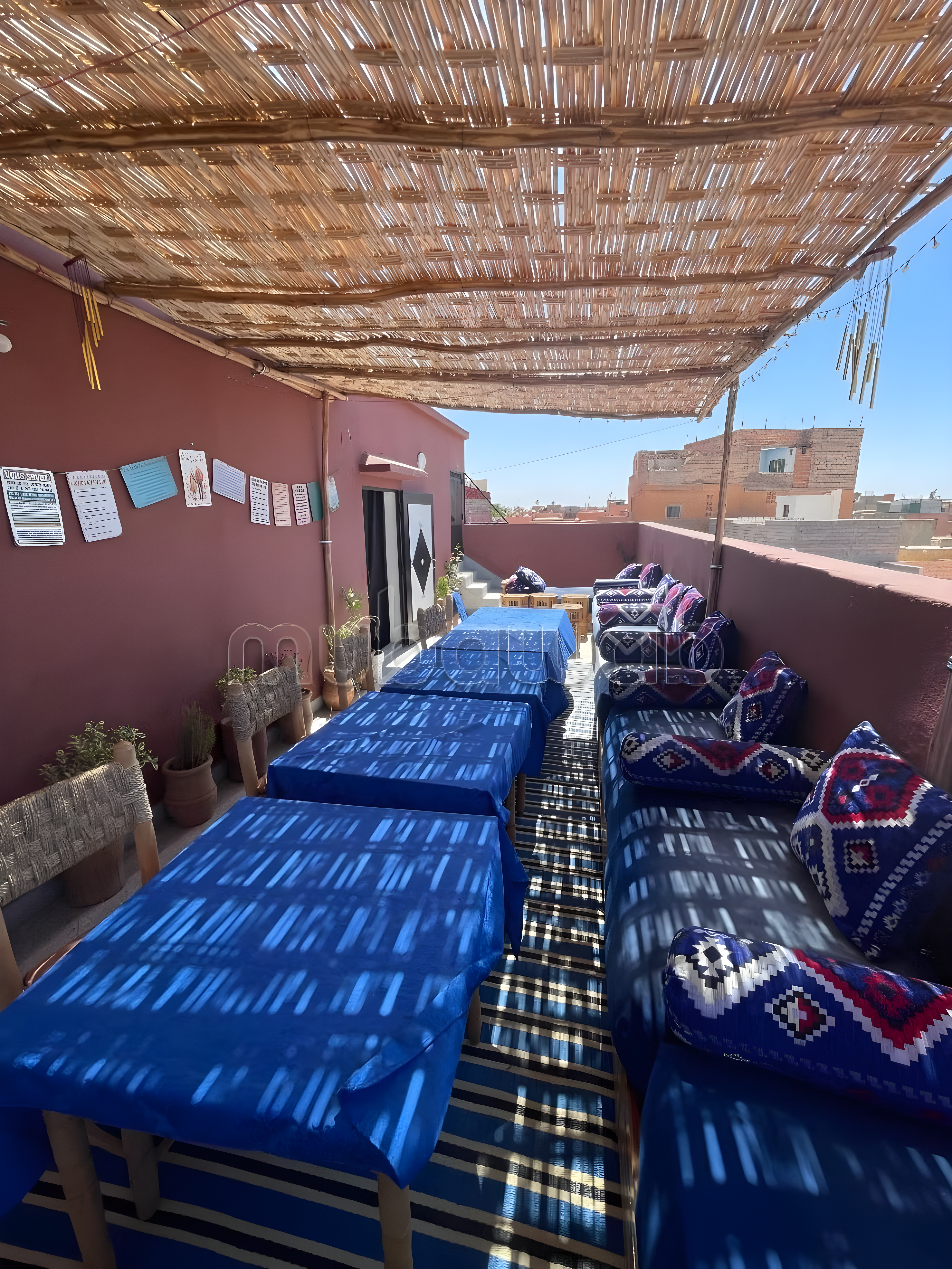 Rooftop seating area with shaded structure in Ben Saleh guesthouse.