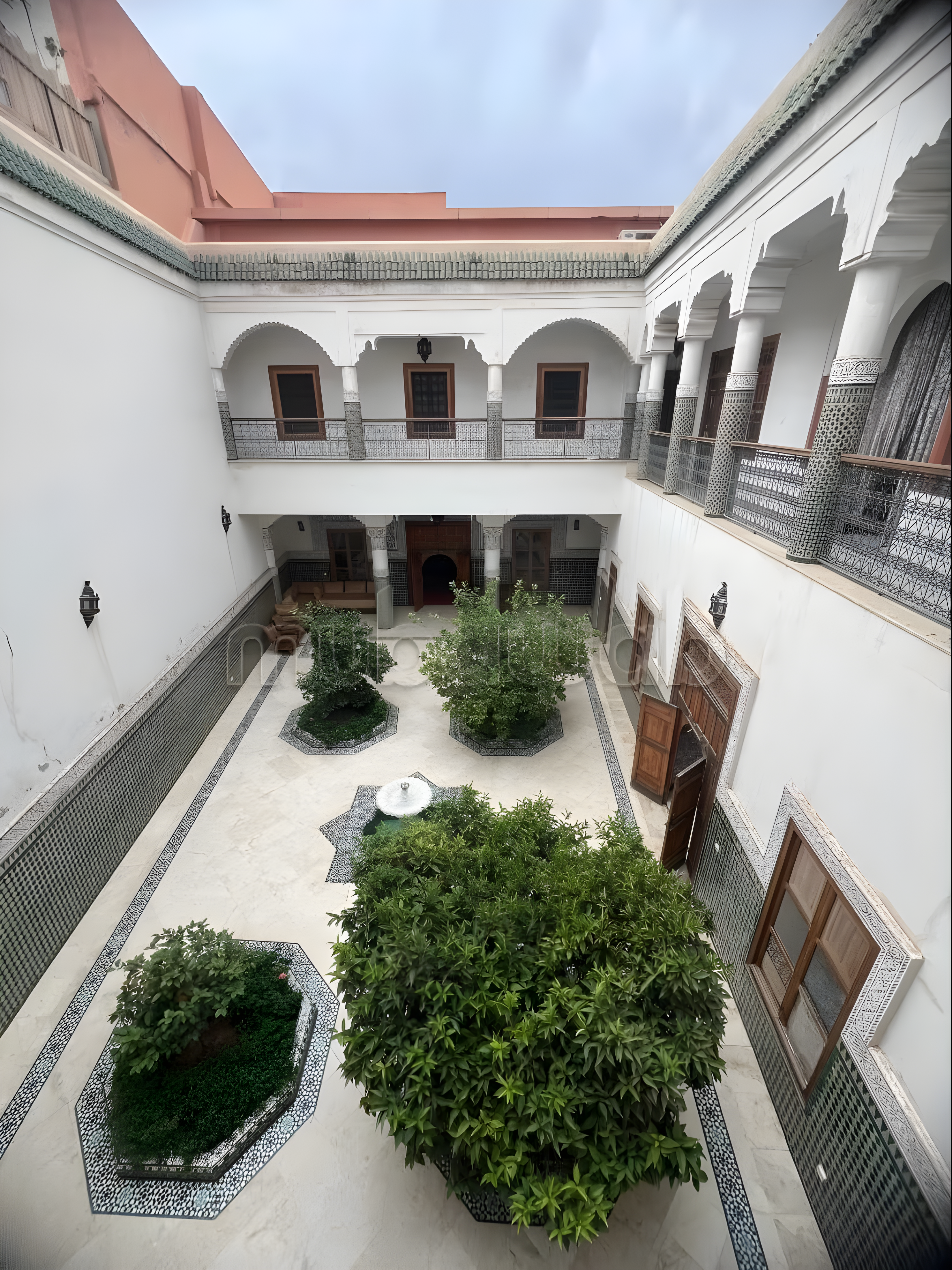Moroccan courtyard in El Hara with arched doorways and tiled walls.
