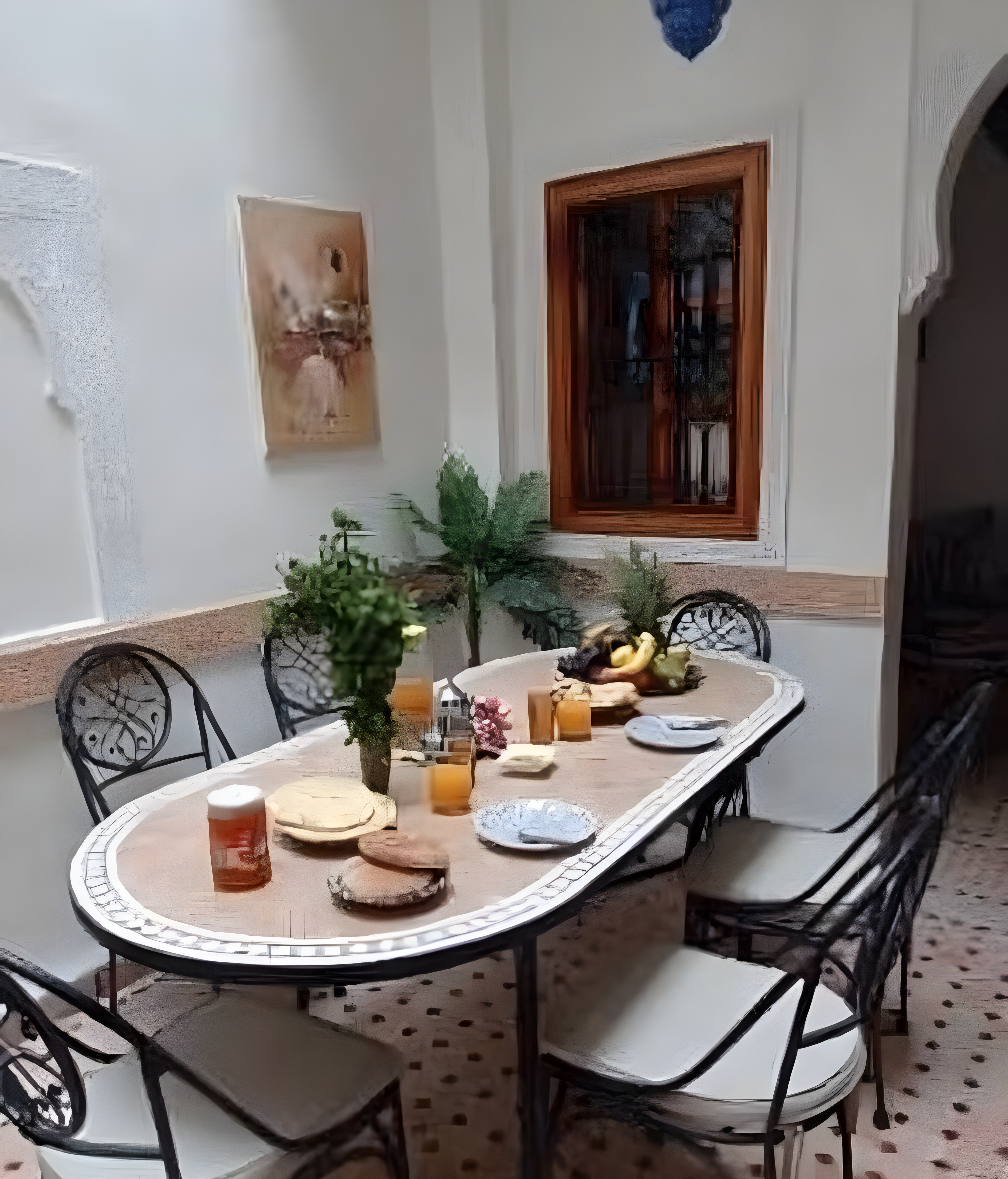 Moroccan patio in Mouassine with dining arrangement and traditional decor.
