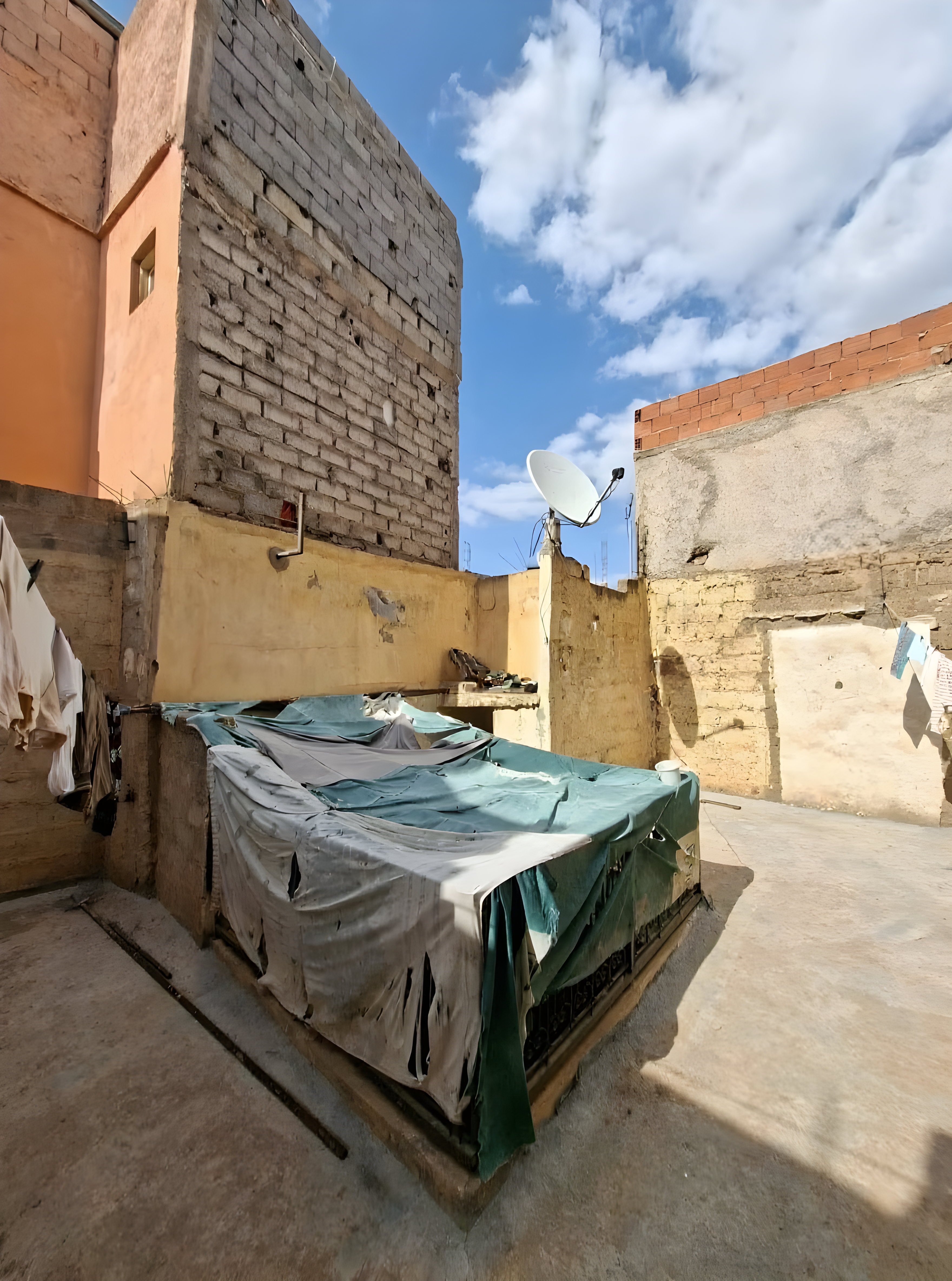 Unfinished rooftop in Berrima with drying clothes and a satellite dish.